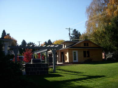 Side view of new pergola and beginning stages of new garage.