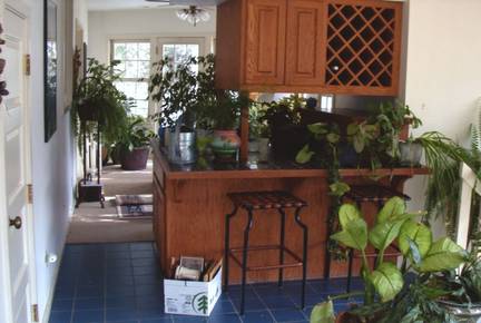 Before: Wet bar and wine rack area that later became the new china cabinet with built in stained glass and breakfast nook.