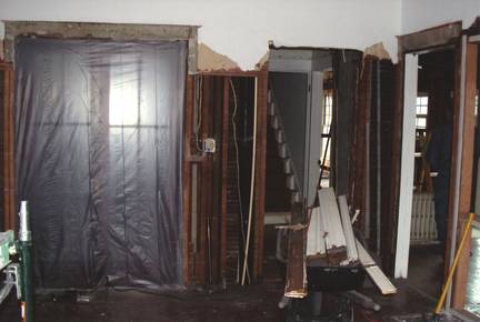 Before: Demo work taking place to relocate doorways from hallway and new bathroom into new living room.