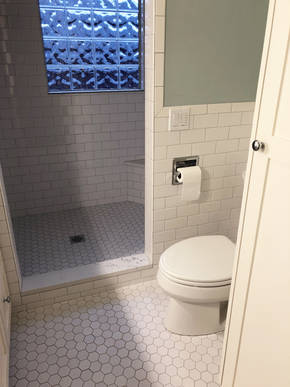 View from doorway of new linen closet and toilet which was moved from the opposite wall to make room for vanity.