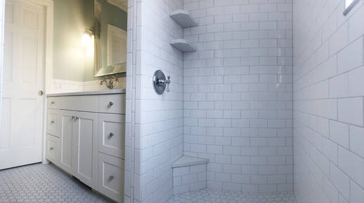 Expanded view in shower towards vanity and pocket door.