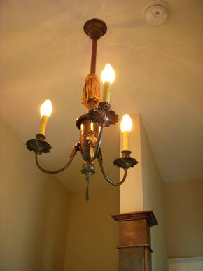 Close attention was paid to the smaller details such as this antique light fixture, but even the corner of the wall was custom wrapped in wood to give it that extra touch.
