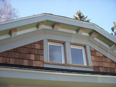 New dormer windows above the garage bays feature new soffit.